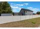 Exterior view of the home, with a long privacy fence and screened-in pool area at 1010 Sugarberry Trl, Oviedo, FL 32765