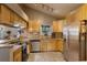 Spacious kitchen featuring stainless steel appliances, granite countertops, and wood cabinets at 1010 Sugarberry Trl, Oviedo, FL 32765