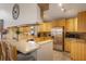 Well-lit kitchen with stainless steel appliances, a breakfast bar, and granite countertops at 1010 Sugarberry Trl, Oviedo, FL 32765