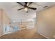 Loft area featuring carpeting, a white railing, and overhead ceiling fan and lighting at 1010 Sugarberry Trl, Oviedo, FL 32765