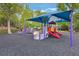 Colorful community playground with slides, climbing structures, and soft landing surface at 1010 Sugarberry Trl, Oviedo, FL 32765