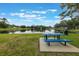 Scenic pond view with a fountain and a picnic table, perfect for relaxing outdoors at 1010 Sugarberry Trl, Oviedo, FL 32765