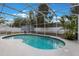 Screened-in pool featuring a spacious patio area, perfect for relaxing and entertaining at 1010 Sugarberry Trl, Oviedo, FL 32765