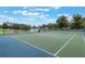 Community tennis court with well-maintained surface, net, and fencing at 1010 Sugarberry Trl, Oviedo, FL 32765