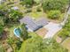 Aerial view of the single-story home showing an in-ground pool, spacious backyard, and mature trees at 106 Pine Tree Dr, Ormond Beach, FL 32174