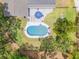 Aerial view of the property showcasing the pool, patio, and surrounding yard and landscaping at 106 Pine Tree Dr, Ormond Beach, FL 32174