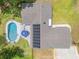 An aerial view of the home with a pool and solar panels at 106 Pine Tree Dr, Ormond Beach, FL 32174