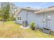 Landscaped backyard with an HVAC unit, potted plant, and chain link fence at 106 Pine Tree Dr, Ormond Beach, FL 32174