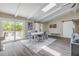 Open dining area with vaulted ceilings, skylights, barn doors, and view to the pool at 106 Pine Tree Dr, Ormond Beach, FL 32174