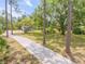 Long driveway leading to a well-maintained home, framed by mature trees and lush landscaping at 106 Pine Tree Dr, Ormond Beach, FL 32174