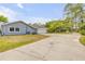 Paved driveway leading to the side-entry garage, highlighting the well-maintained exterior and landscaping at 106 Pine Tree Dr, Ormond Beach, FL 32174