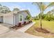 Home exterior featuring a well-kept lawn, manicured landscaping, and a side-entry garage at 106 Pine Tree Dr, Ormond Beach, FL 32174