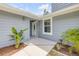 Close-up view of the front entrance with immaculate landscaping around the front entryway at 106 Pine Tree Dr, Ormond Beach, FL 32174