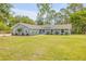 Charming single-story home with a well-manicured lawn, tidy landscaping, and a freshly painted exterior at 106 Pine Tree Dr, Ormond Beach, FL 32174