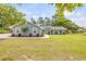 Inviting single-story home with a manicured lawn and charming landscaping provides great curb appeal at 106 Pine Tree Dr, Ormond Beach, FL 32174