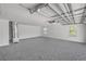 Clean and bright garage interior with epoxy floors and ample space at 106 Pine Tree Dr, Ormond Beach, FL 32174