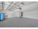 Spacious garage interior featuring epoxy floors and ample storage space at 106 Pine Tree Dr, Ormond Beach, FL 32174