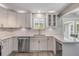 Updated kitchen features stainless appliances, modern cabinets, quartz countertops, and a wine refrigerator at 106 Pine Tree Dr, Ormond Beach, FL 32174