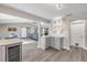 Bright open-concept kitchen with updated cabinets, quartz countertops, wine storage, and modern finishes at 106 Pine Tree Dr, Ormond Beach, FL 32174