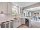 Bright kitchen with quartz countertops, updated cabinets, stainless steel appliances, and a wine refrigerator at 106 Pine Tree Dr, Ormond Beach, FL 32174
