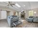 Sunlit living room with stone fireplace, vaulted ceilings and stylish furnishings at 106 Pine Tree Dr, Ormond Beach, FL 32174