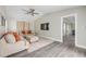 Spacious living room with vaulted ceilings, large windows, neutral color palette, and easy access to other rooms at 106 Pine Tree Dr, Ormond Beach, FL 32174