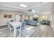 An open concept living space has a stone fireplace, vaulted ceilings, and skylights at 106 Pine Tree Dr, Ormond Beach, FL 32174