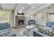 Living room with stone fireplace, hardwood floors, and comfortable seating at 106 Pine Tree Dr, Ormond Beach, FL 32174