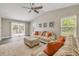 Bright living room boasts neutral decor, luxury vinyl plank flooring, and easy access to an outdoor patio at 106 Pine Tree Dr, Ormond Beach, FL 32174