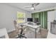 Bright home office with a large window, work station, and comfortable chair at 106 Pine Tree Dr, Ormond Beach, FL 32174