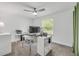 Bright home office with a large window, work station, and comfortable chair at 106 Pine Tree Dr, Ormond Beach, FL 32174