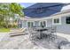 Beautiful patio with comfortable lounge chairs and a dining set under a large umbrella at 106 Pine Tree Dr, Ormond Beach, FL 32174