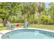 Relaxing poolside seating area with chairs and landscaping near the inviting pool at 106 Pine Tree Dr, Ormond Beach, FL 32174