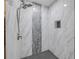Detailed shower featuring marble tile, a sleek shower head, and a built-in niche at 106 Pine Tree Dr, Ormond Beach, FL 32174