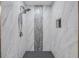 Modern shower featuring marble tile and a sleek shower head at 106 Pine Tree Dr, Ormond Beach, FL 32174