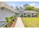 Landscaped walkway leading to the entrance of the beautifully maintained and updated single-story home at 106 Pine Tree Dr, Ormond Beach, FL 32174