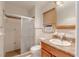 Bathroom featuring a walk-in shower with glass doors and a vanity with solid surface countertop at 1108 Gibson St, Leesburg, FL 34748