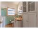 Bathroom with a toilet, sink with granite countertop, and storage cabinet at 1108 Gibson St, Leesburg, FL 34748