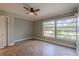 Bedroom showcasing laminate flooring, a ceiling fan, and a large window at 1108 Gibson St, Leesburg, FL 34748