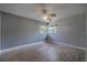 Bedroom features laminate flooring, ceiling fan, and natural light from two windows at 1108 Gibson St, Leesburg, FL 34748
