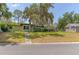 Quaint single-story home with a well-manicured lawn and mature trees, offering a serene and inviting atmosphere at 1108 Gibson St, Leesburg, FL 34748