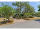 Charming home with a brick driveway and mature trees creating a serene landscape at 1108 Gibson St, Leesburg, FL 34748