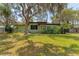 Charming single-story home with a well-maintained lawn and mature trees at 1108 Gibson St, Leesburg, FL 34748