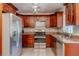 Well-equipped kitchen featuring stainless steel appliances and rich wood cabinetry at 1108 Gibson St, Leesburg, FL 34748