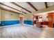 Expansive living room that has beamed ceilings and flows into kitchen at 1108 Gibson St, Leesburg, FL 34748