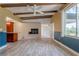 Living room featuring fireplace and an open layout to kitchen area at 1108 Gibson St, Leesburg, FL 34748