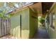 Exterior view of a small, green, utility shed attached to the home, offering extra storage space at 1108 Gibson St, Leesburg, FL 34748