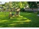 Lush backyard featuring well-maintained lawn, mature trees, and outdoor seating area for relaxing at 1118 Ne 17Th Ave, Ocala, FL 34470