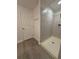 Tiled stand-up shower with updated flooring and white door in bathroom at 1118 Ne 17Th Ave, Ocala, FL 34470