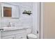 Bathroom featuring a white vanity with sink, toilet, and decorative wall accents at 1118 Ne 17Th Ave, Ocala, FL 34470